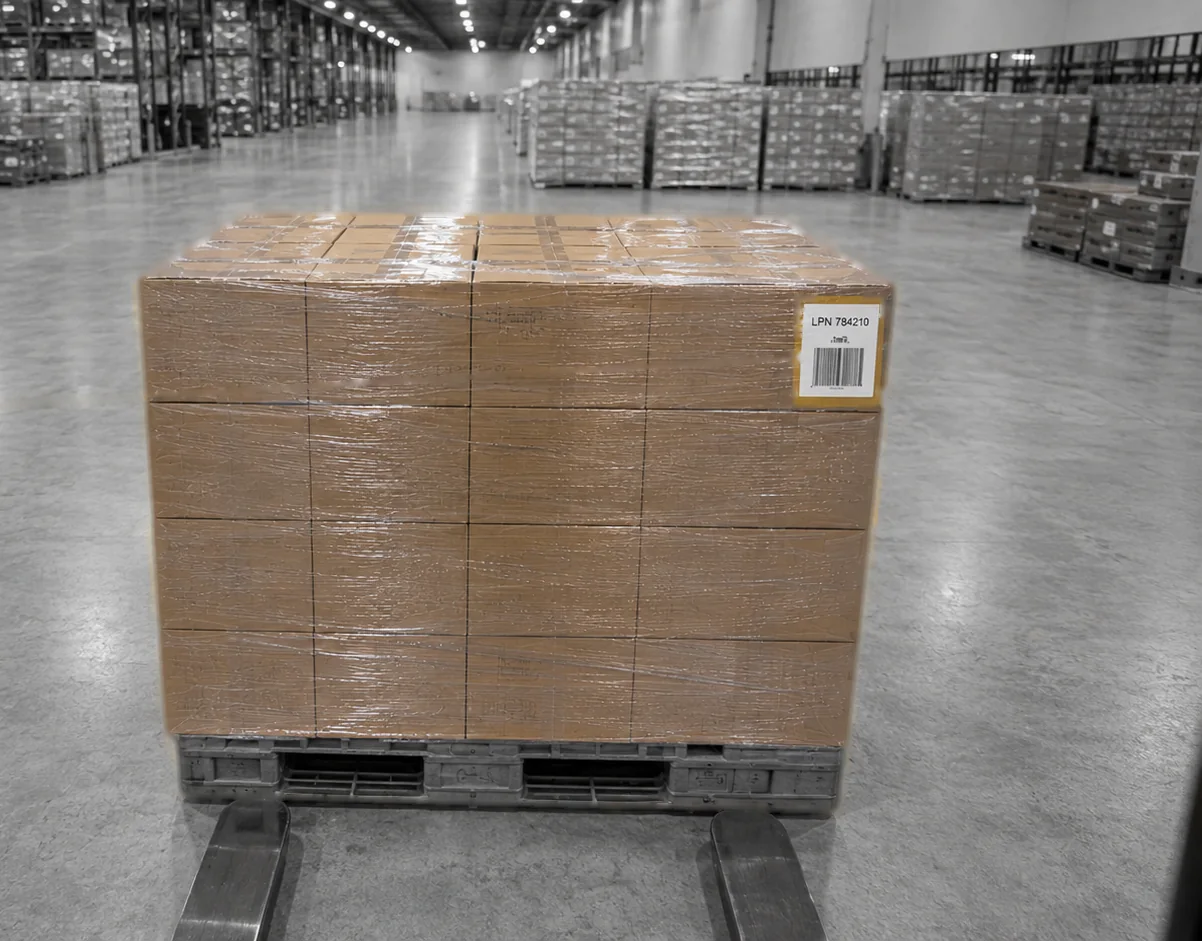 A pallet on forks in a warehouse aisle, its LPN label facing the camera.